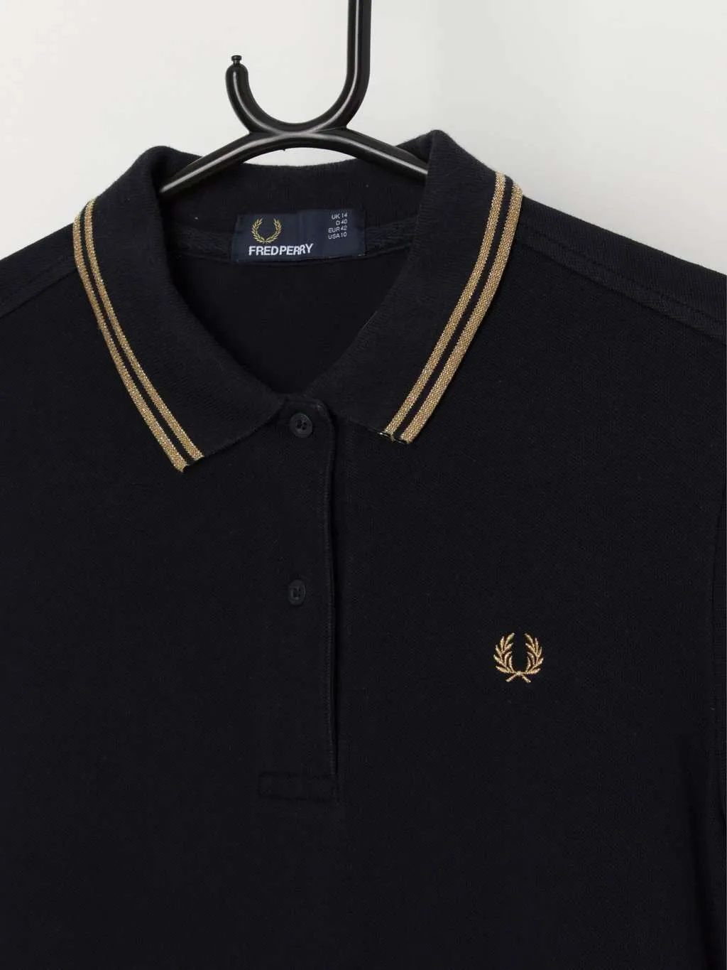 Fred Perry women’s polo shirt in navy with gold trim – Medium / Large